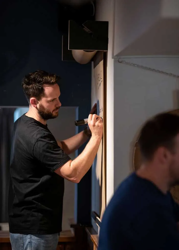 A member of staff writing on the specials board